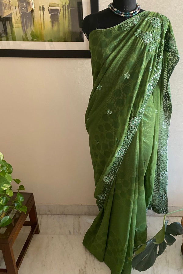 SITARA- A STYLISH OLIVE GREEN GEORGETTE SAREE WITH SEQUINS AND EMBROIDERY ALONG THE BORDER AND AANCHAL