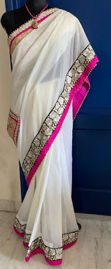 KAAMIYA- A SOOTHING CREAM PURE GEORGETTE WITH AN ELABORATE SEQUIN, EMBROIDERY AND PEARL BORDER