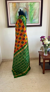 TVESHA- ORANGE GHARCHOLA WITH BANDHANI CHOWK AND GREEN BORDER