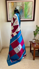 PRABHATHI – WHITE PUTAPAKKA IKKAT WITH TEAL BLUE ZARI BORDER
