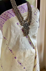 DIPANWITA – CREAM ASSAM SILK WITH ABUNDANT PURPLE FLORALS
