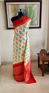 AVINI – VIBRANT RAJKOT PATOLA IN CREAM AND ORANGE
