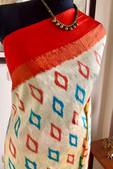 AVINI – VIBRANT RAJKOT PATOLA IN CREAM AND ORANGE
