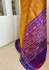 SUSHWETA- OCHRE KHANDUA SILK WITH BANDHA AND FLORAL MOTIFS