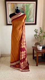 SNEHASMITA – BURNT ORANGE BOMKAI WITH A DISTINCTIVE GEOMETRIC AANCHAL
