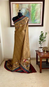 MANUBHA – DARK BEIGE TUSSAR WITH FLORAL PRINTS ON BORDER AND AANCHAL