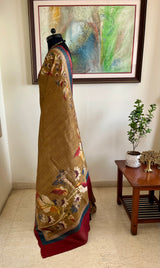 MANUBHA – DARK BEIGE TUSSAR WITH FLORAL PRINTS ON BORDER AND AANCHAL