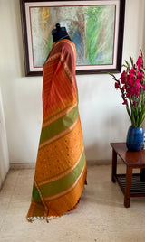 SRUJANA – ORANGE VELDHARI COTTON WITH TEMPLE PEACOCK BORDER
