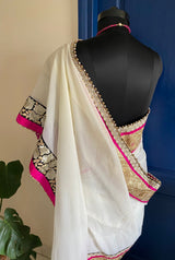 KAAMIYA- A SOOTHING CREAM PURE GEORGETTE WITH AN ELABORATE SEQUIN, EMBROIDERY AND PEARL BORDER