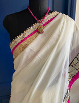 KAAMIYA- A SOOTHING CREAM PURE GEORGETTE WITH AN ELABORATE SEQUIN, EMBROIDERY AND PEARL BORDER