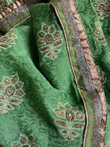 ARUSHI- A PRINTED PURE GEORGETTE IN GREEN WITH  EMBROIDERY AND SEQUIN WORK IN THE BODY, SEQUINED BORDER