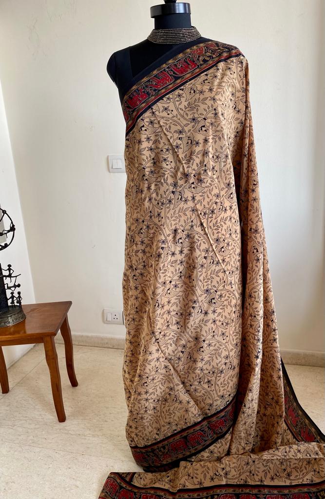 EMMA- PURE, ITALIAN CREPE IN BEIGE WITH PRINTED FLORAL MOTIFS IN BLACK AND A CONTRAST AANCHAL IN RED WITH FLORAL AND ANIMAL MOTIFS