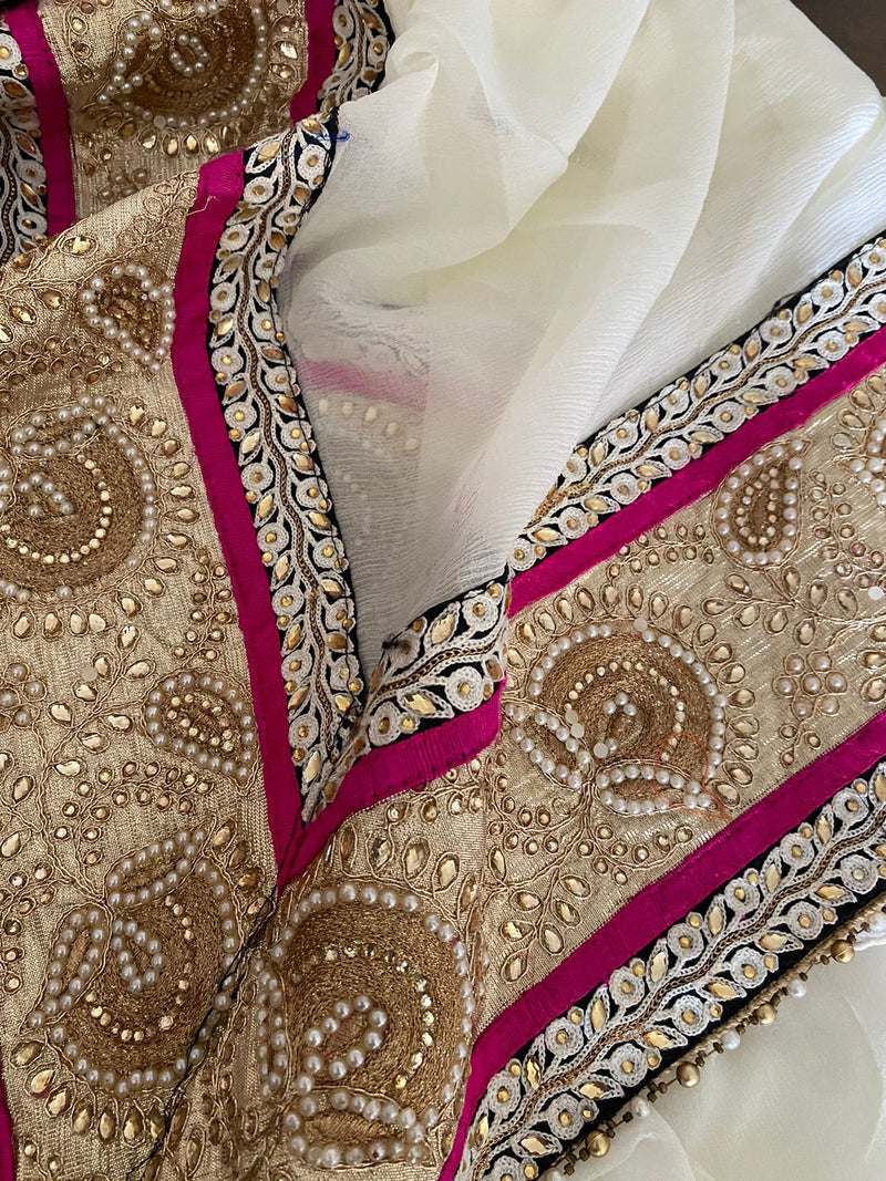 KAAMIYA- A SOOTHING CREAM PURE GEORGETTE WITH AN ELABORATE SEQUIN, EMBROIDERY AND PEARL BORDER