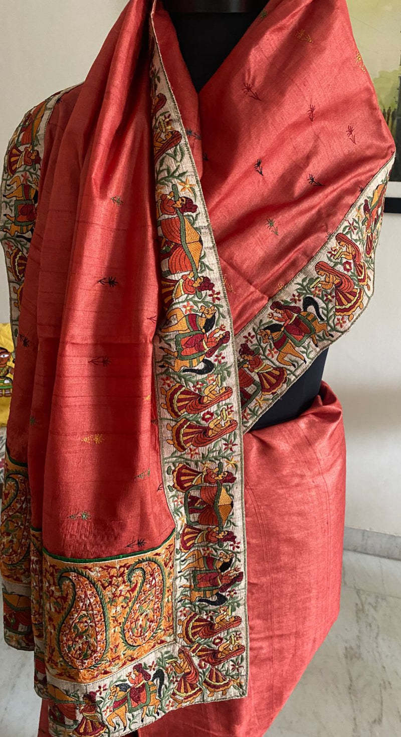 TASHI- A BEAUTFUL BURNT ORANGE TUSSAR SILK WITH SMALL FLORAL MOTIFS EMBROIDERED IN THE BODY AND DANCING GIRLS EMBROIDERED IN THE BORDER AND AANCHAL