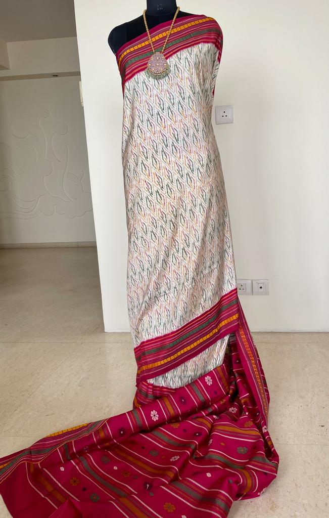 MEENU- REVEL IN THE ALLURE OF THIS UNCONVENTIONAL KANJIVARAM SAREE IN OFFWHITE, ADORNED WITH A CAPTIVATING ARRAY OF MULTICOLOURED IKKAT WEAVES