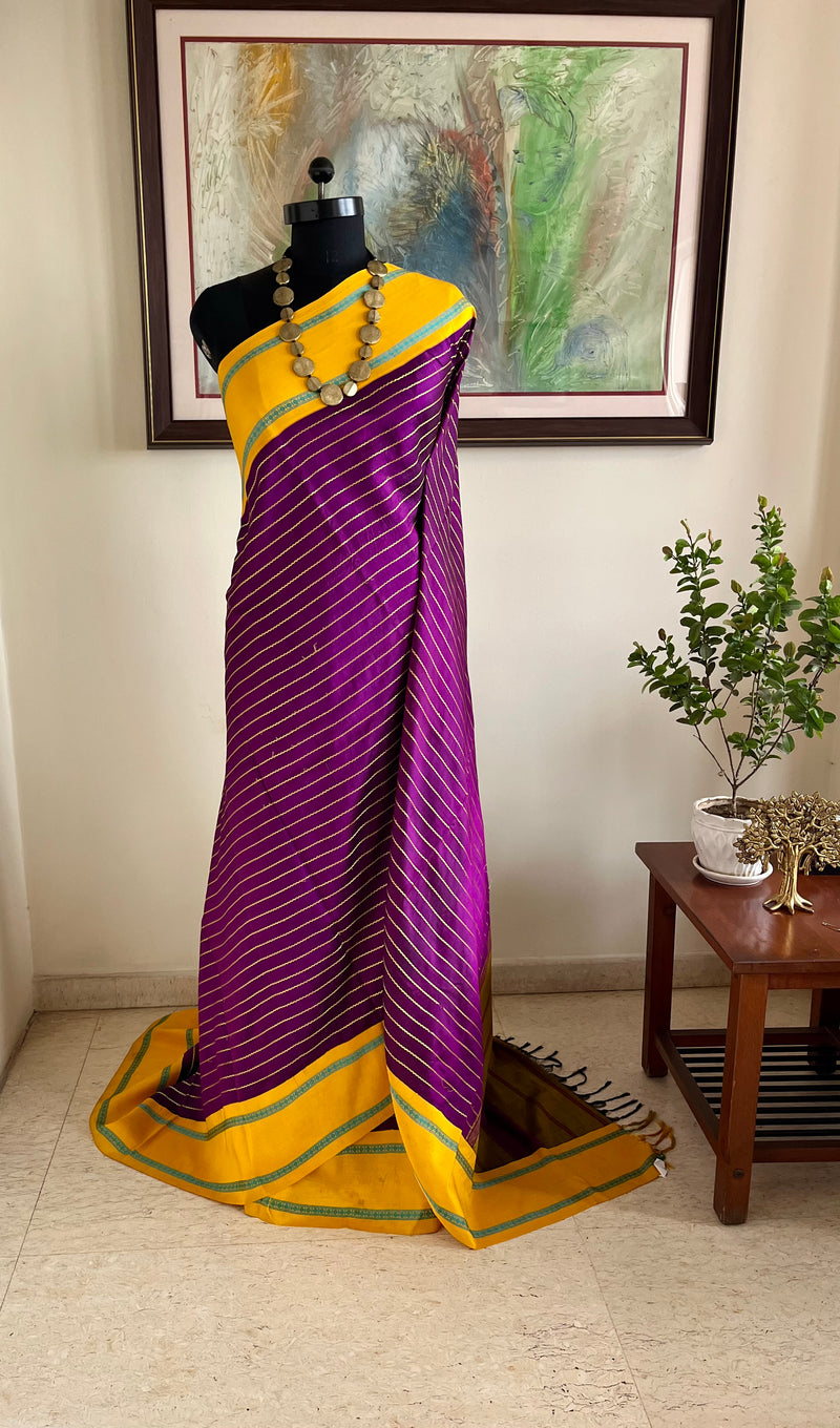 SHANKARI – VELDHARI KANJIVARAM IN RICH PURPLE WITH YELLOW BORDER DETAILS