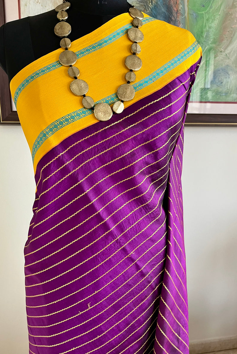 SHANKARI – VELDHARI KANJIVARAM IN RICH PURPLE WITH YELLOW BORDER DETAILS