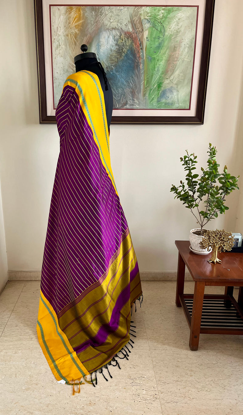 SHANKARI – VELDHARI KANJIVARAM IN RICH PURPLE WITH YELLOW BORDER DETAILS