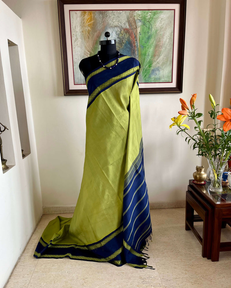 SAYURI – LEAF GREEN KORVAI KANJIVARAM WITH NAVY BLUE BORDERS
