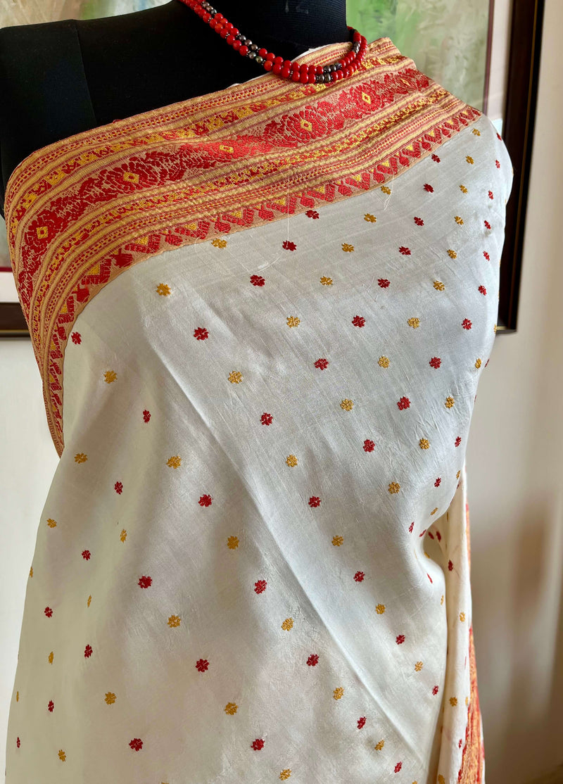 JUTHIKA – WHITE ASSAM SILK WITH RED AND MUSTARD FLORALS