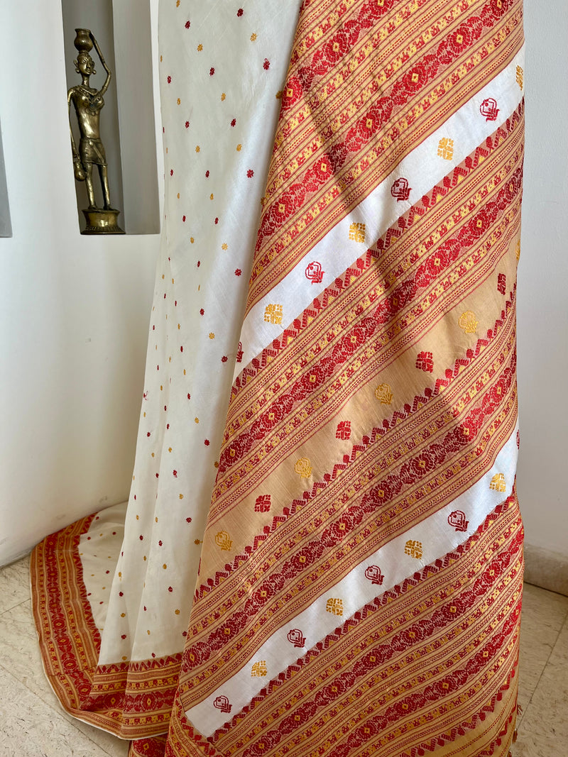 JUTHIKA – WHITE ASSAM SILK WITH RED AND MUSTARD FLORALS