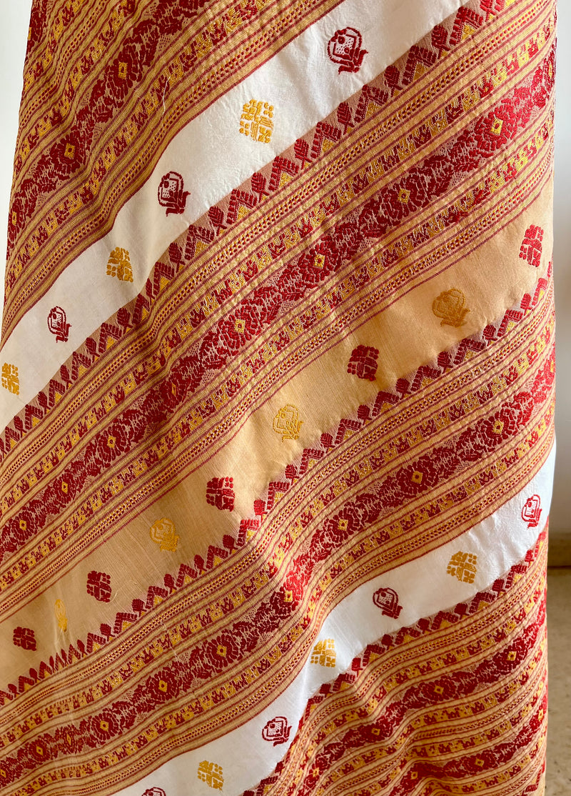 JUTHIKA – WHITE ASSAM SILK WITH RED AND MUSTARD FLORALS