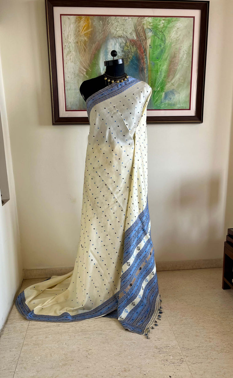 SUBORNA – CREAM ASSAM SILK WITH BLUE FLORAL MOTIFS