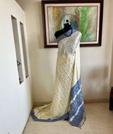 SUBORNA – CREAM ASSAM SILK WITH BLUE FLORAL MOTIFS