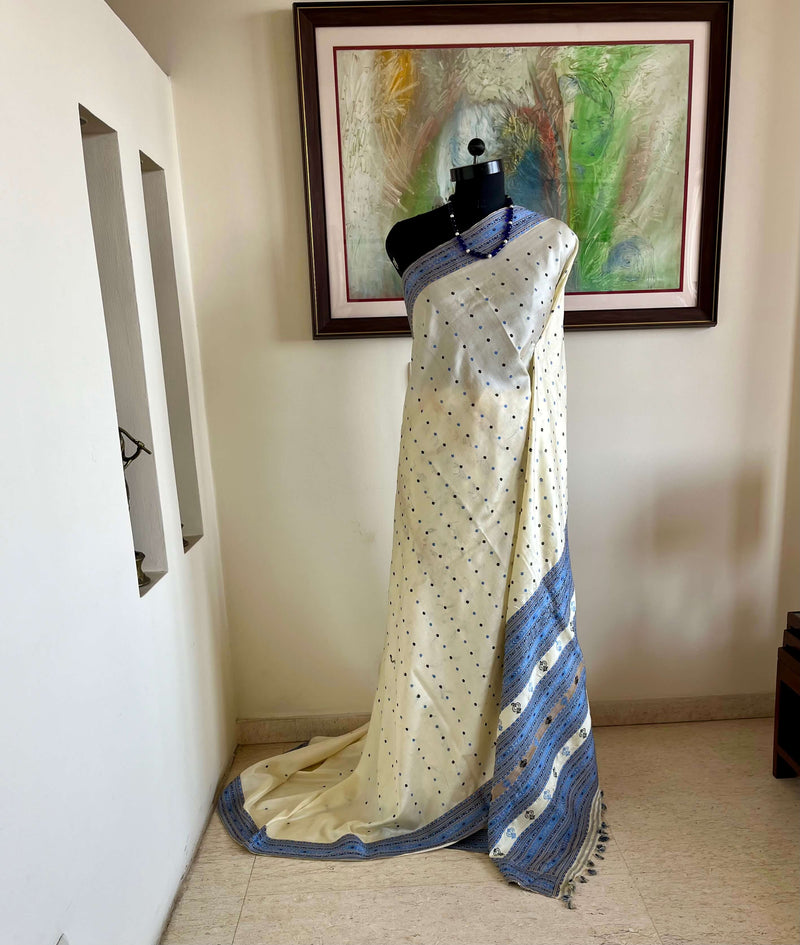 SUBORNA – CREAM ASSAM SILK WITH BLUE FLORAL MOTIFS