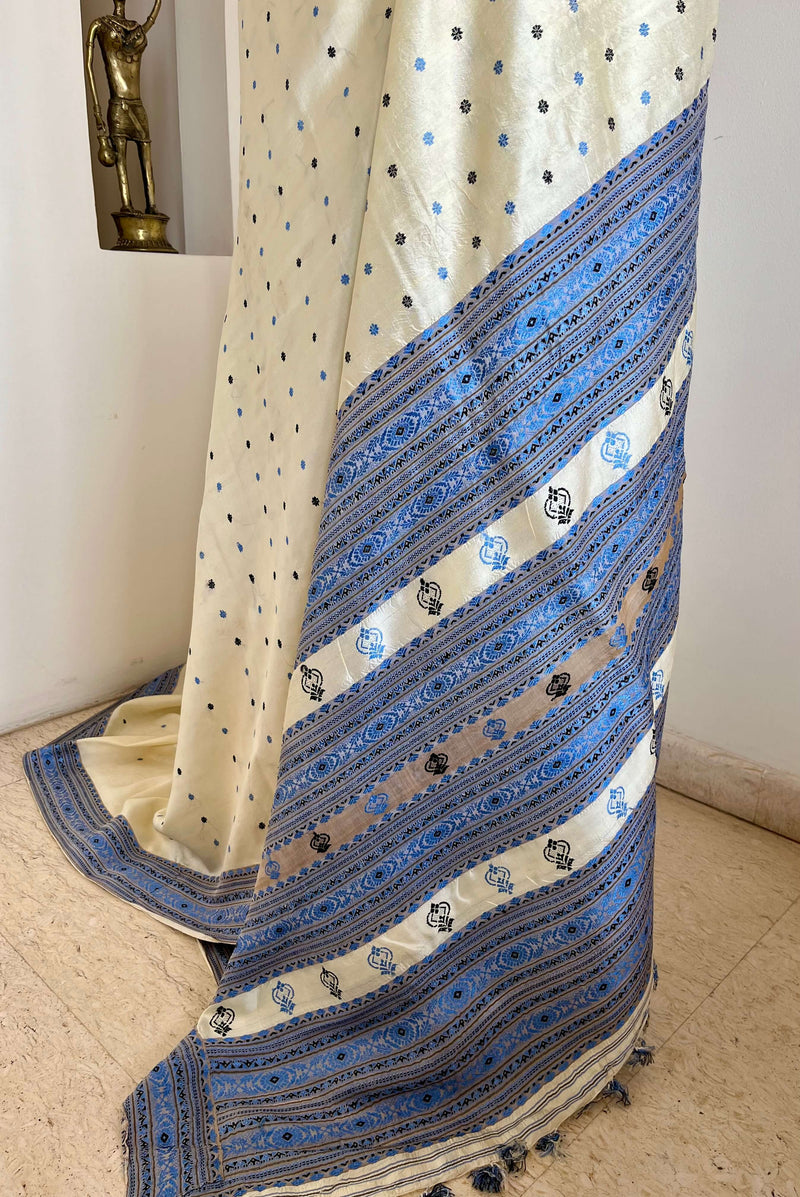 SUBORNA – CREAM ASSAM SILK WITH BLUE FLORAL MOTIFS