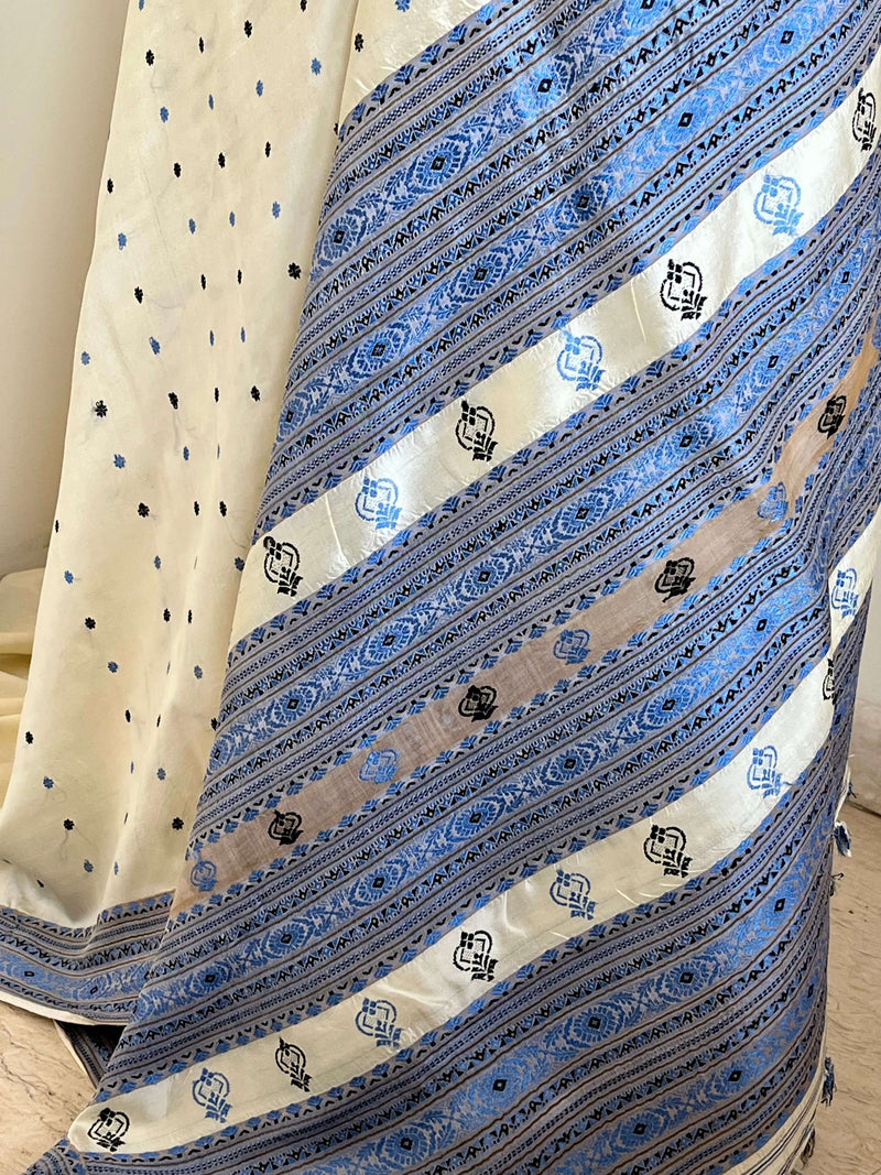 SUBORNA – CREAM ASSAM SILK WITH BLUE FLORAL MOTIFS