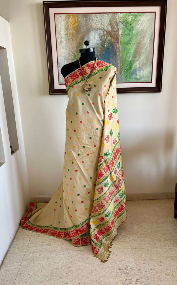 REENU – CREAM ASSAM TUSSAR SILK SAREE WITH MULTICOLOR MOTIFS