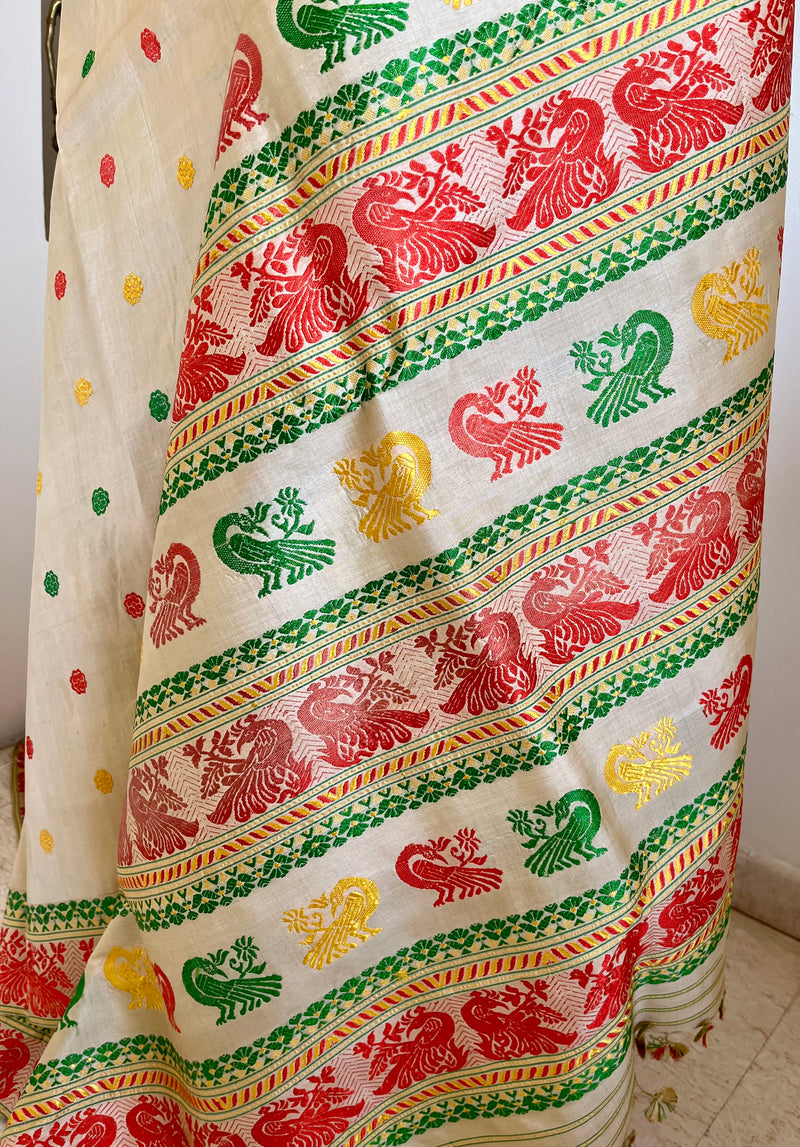 REENU – CREAM ASSAM TUSSAR SILK SAREE WITH MULTICOLOR MOTIFS