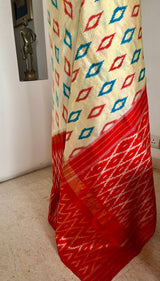 AVINI – VIBRANT RAJKOT PATOLA IN CREAM AND ORANGE