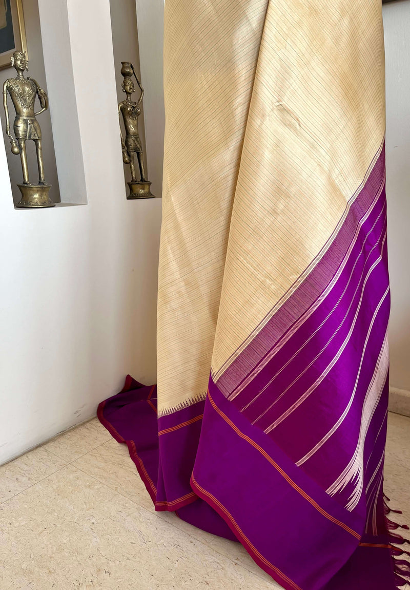KARTIKA-KORVAI KANJIVARAM IN CREAM WITH PURPLE PETNI AANCHAL