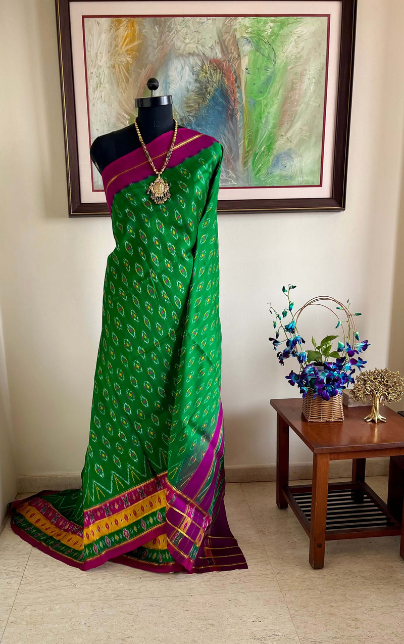 TANISHA- AN ELEGANT GREEN AND MAGENTA PATOLA SILK SAREE, A TIMELESS TALE OF BEAUTY AND ARTISTRY