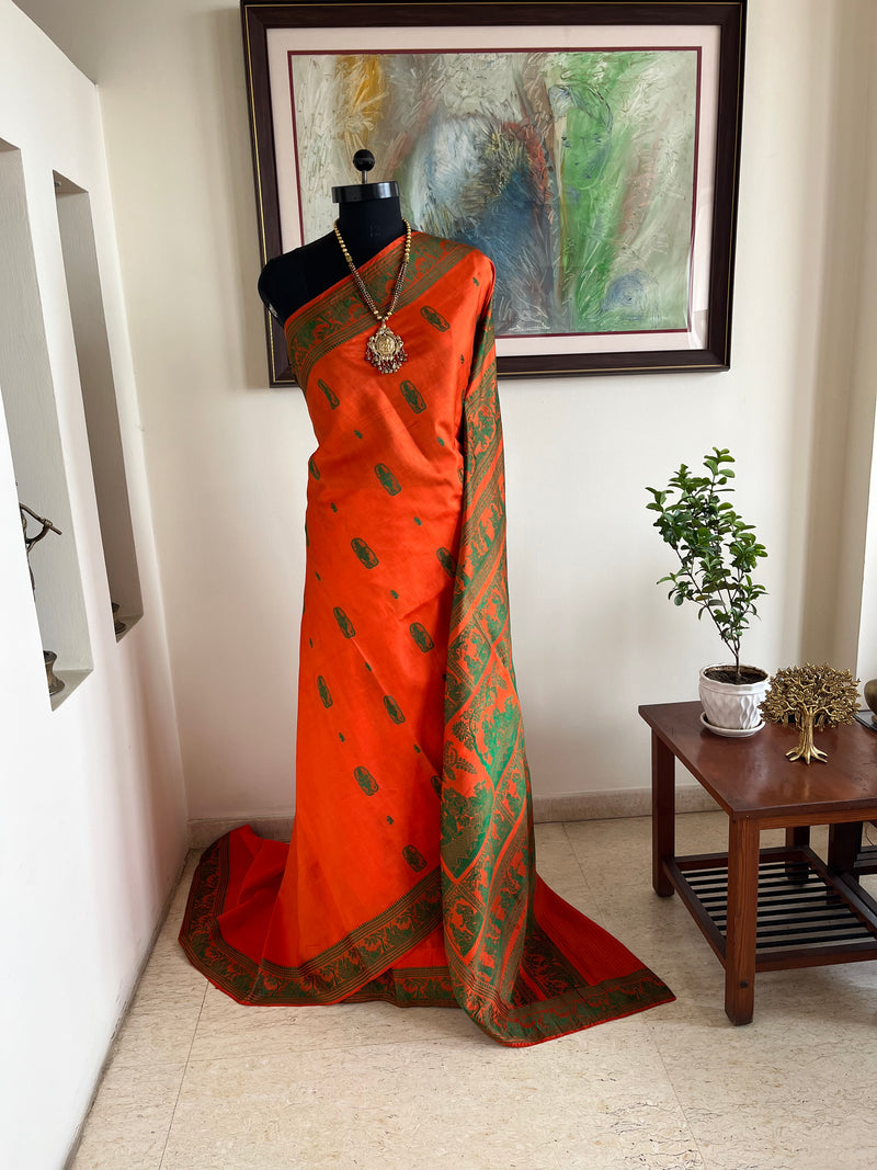 SANJOLI – ORANGE BALUCHARI SILK WITH KRISHNA RAS LEELA MOTIFS