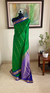 ROCHISHA – GREEN KANJIVARAM WITH PURPLE TEMPLE MOTIF BORDER