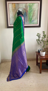 ROCHISHA – GREEN KANJIVARAM WITH PURPLE TEMPLE MOTIF BORDER