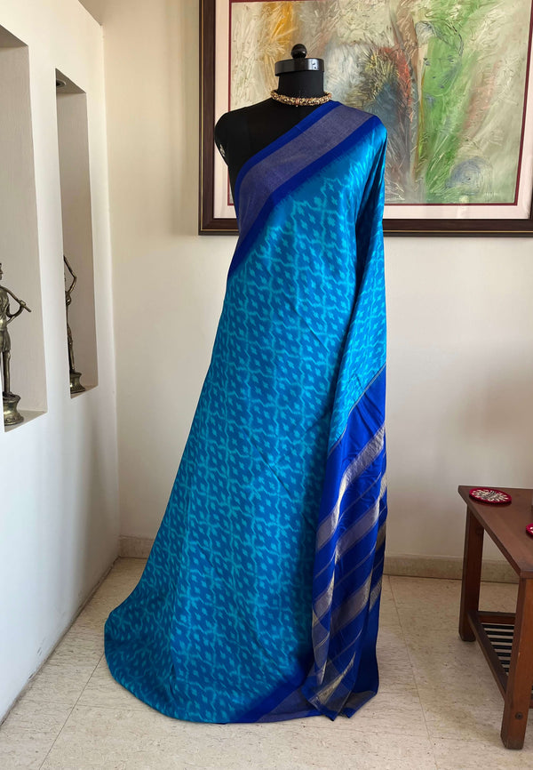 MIHIRA- SOOTHING BLUE PATOLA WITH IKKAT MOTIFS, ZARI AND PURPLISH-BLUE BORDER, AANCHAL