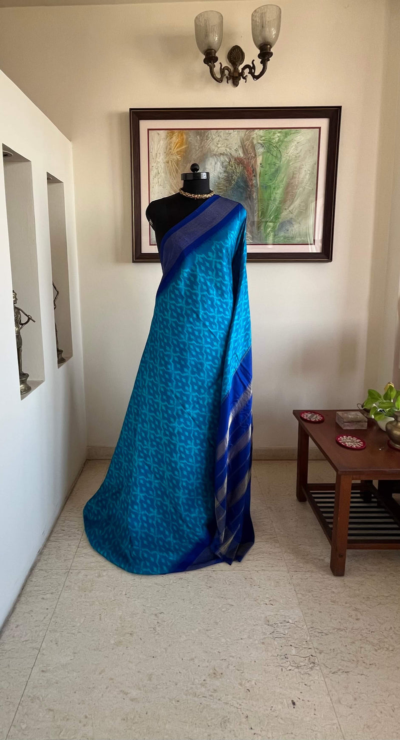 MIHIRA- SOOTHING BLUE PATOLA WITH IKKAT MOTIFS, ZARI AND PURPLISH-BLUE BORDER, AANCHAL