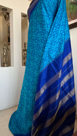 MIHIRA- SOOTHING BLUE PATOLA WITH IKKAT MOTIFS, ZARI AND PURPLISH-BLUE BORDER, AANCHAL