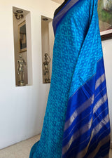 MIHIRA- SOOTHING BLUE PATOLA WITH IKKAT MOTIFS, ZARI AND PURPLISH-BLUE BORDER, AANCHAL