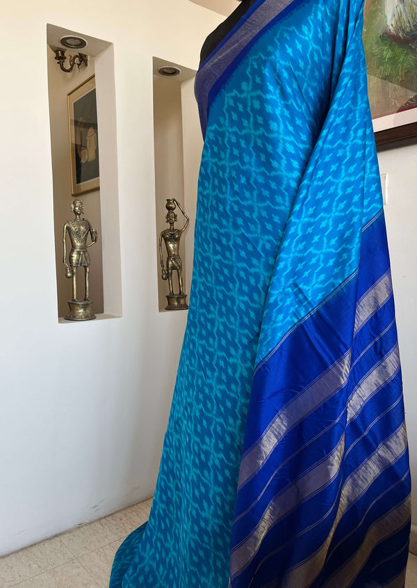 MIHIRA- SOOTHING BLUE PATOLA WITH IKKAT MOTIFS, ZARI AND PURPLISH-BLUE BORDER, AANCHAL