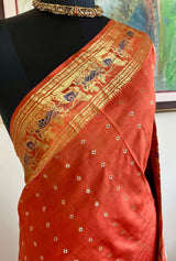 TIYASHI- RUST SWARNACHARI WITH KURUKSHETRA SCENES AND FLORAL LINES IN GOLD