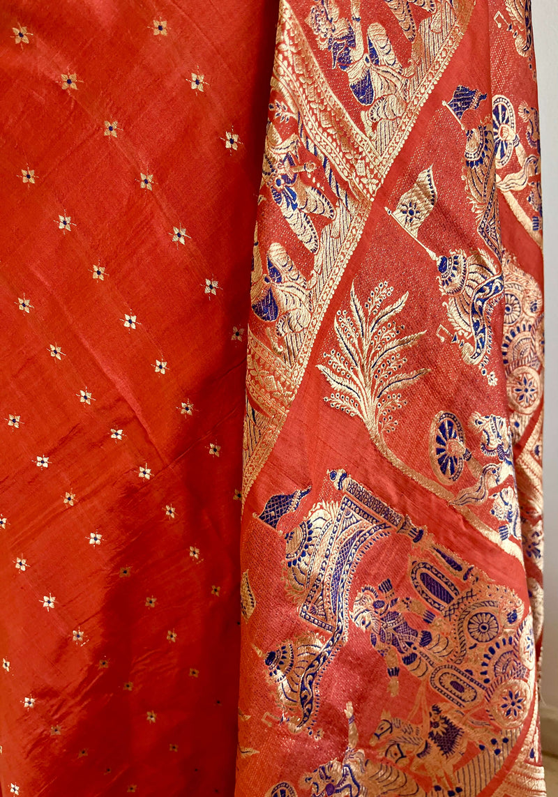 TIYASHI- RUST SWARNACHARI WITH KURUKSHETRA SCENES AND FLORAL LINES IN GOLD