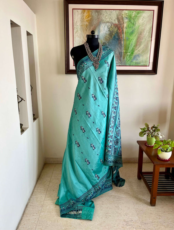 TUMPA- PASTEL BLUE BALUCHARI SAREE WITH KRISHNA’S RAAS LEELA & IKTARA MOTIFS