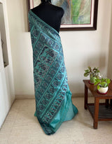 TUMPA- PASTEL BLUE BALUCHARI SAREE WITH KRISHNA’S RAAS LEELA & IKTARA MOTIFS