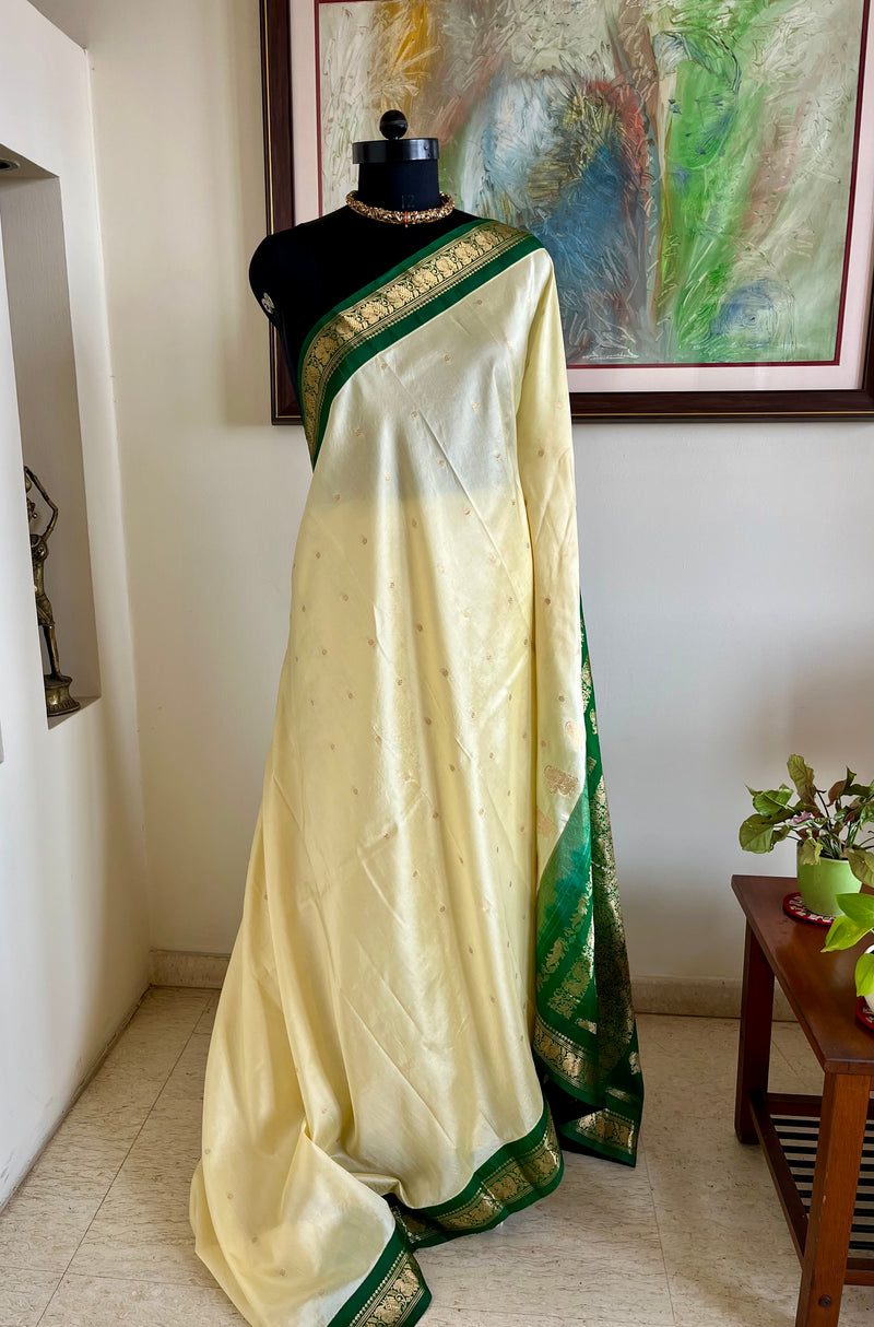 AARUTHIRA- ELEGANT CREAM KANJIVARAM SAREE WITH GREEN ZARI PEACOCK BORDER & BOOTIS