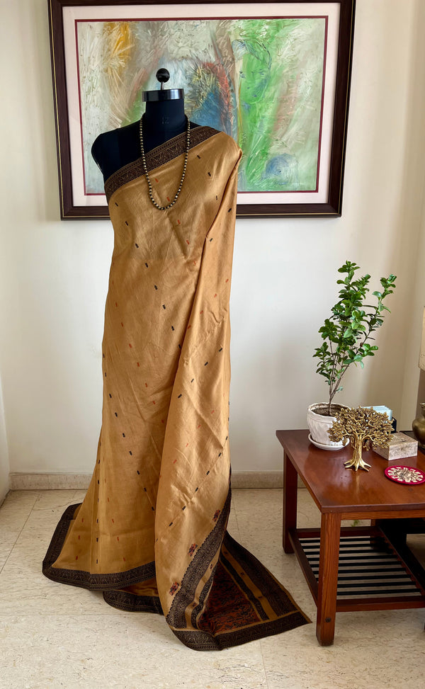 PRIYATHA – DARK BEIGE ASSAM SILK WITH BLACK RED AANCHAL